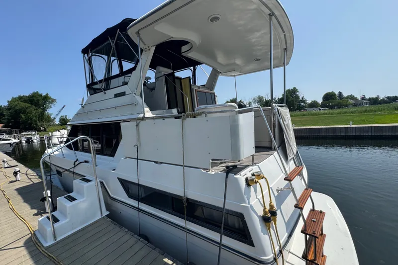 Slide: The Image of 1990 Carver 3807 Aft Cabin Motor Yacht docked at marina, side view. - 7