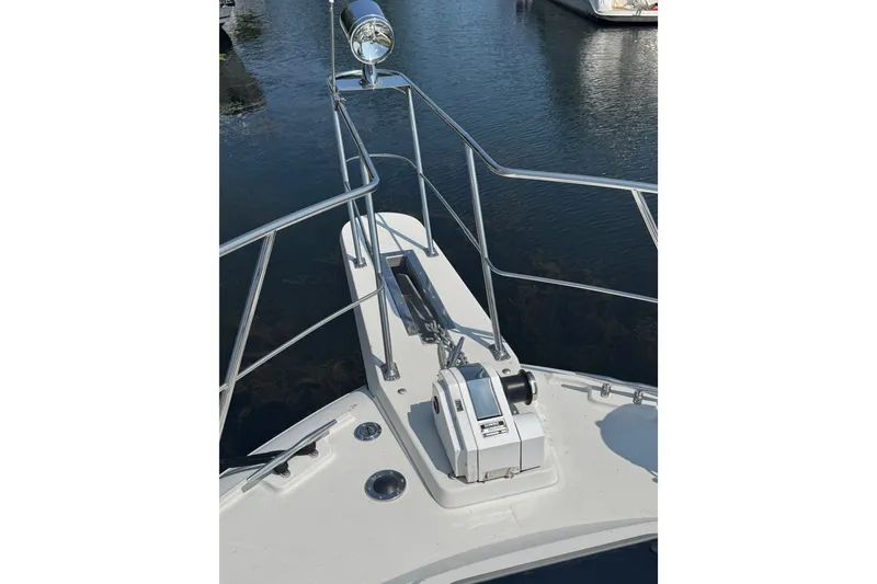 Slide: The Image of Bow of 1990 Carver 3807 Aft Cabin Motor Yacht with anchor and railing. - 14