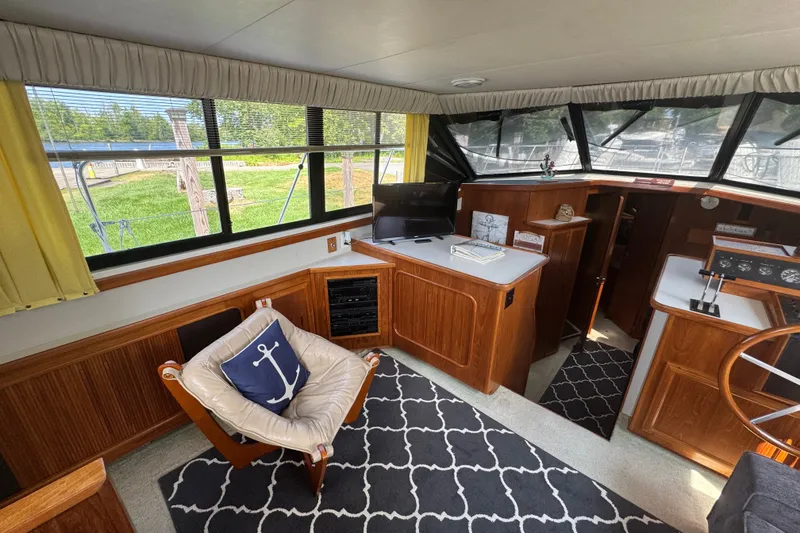Slide: The Image of Interior of 1990 Carver 3807 Aft Cabin Motor Yacht with cozy seating and nautical decor. - 19