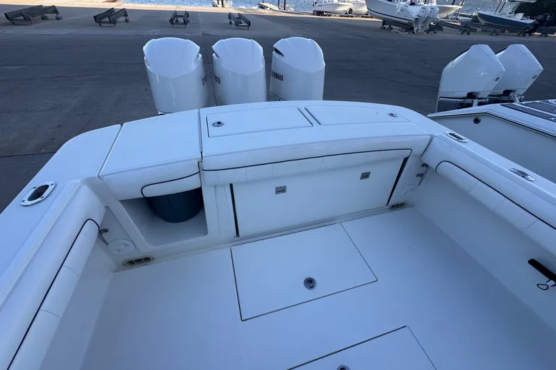 Slide: The Image of 2016 Regulator 34 boat deck with triple outboard engines at marina. - 19