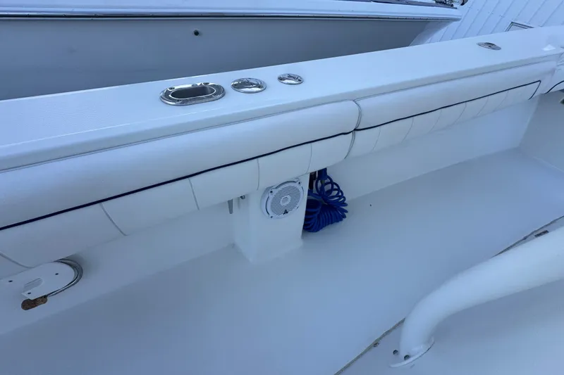 Slide: The Image of 2016 Regulator 34 boat interior with cushioned seating and marine speaker. - 18