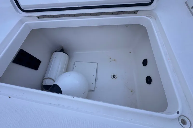 Slide: The Image of Open storage compartment on 2016 Regulator 34 boat with fenders inside. - 24