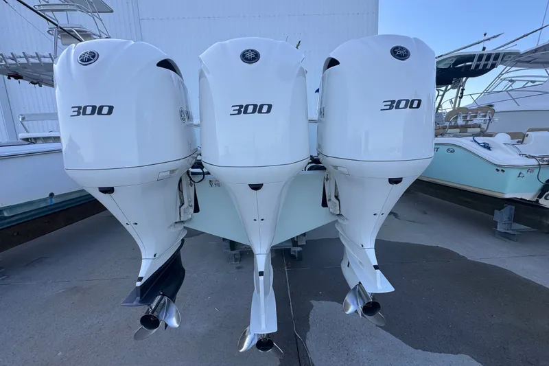 Slide: The Image of Triple Yamaha 300 outboard engines on a 2016 Regulator 34 boat, dockside view. - 5