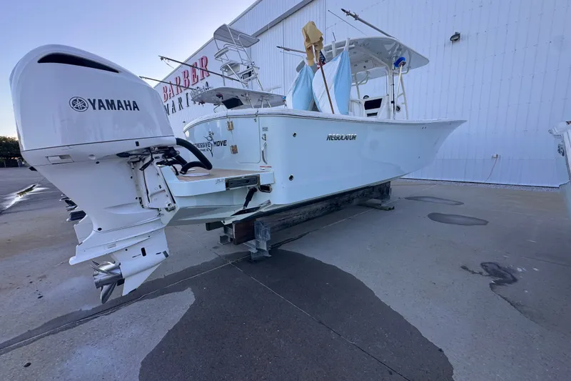 Slide: The Image of 2016 Regulator 34 boat with Yamaha outboard engines at a marina. - 4