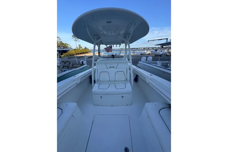Slide: The Image of 2016 Regulator 34 boat interior with seating and T-top, docked at marina. - 11