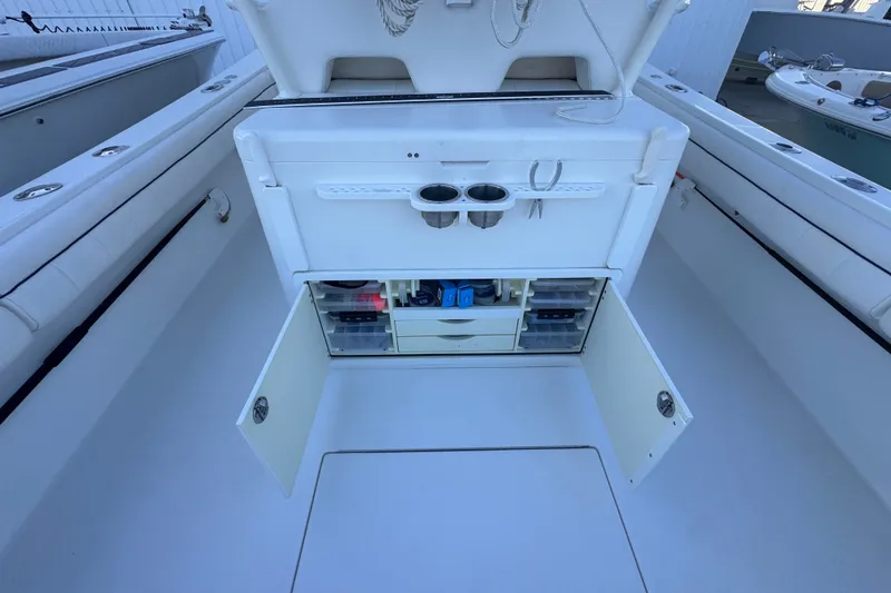 Slide: The Image of 2016 Regulator 34 boat with open storage compartments and fishing gear setup. - 16