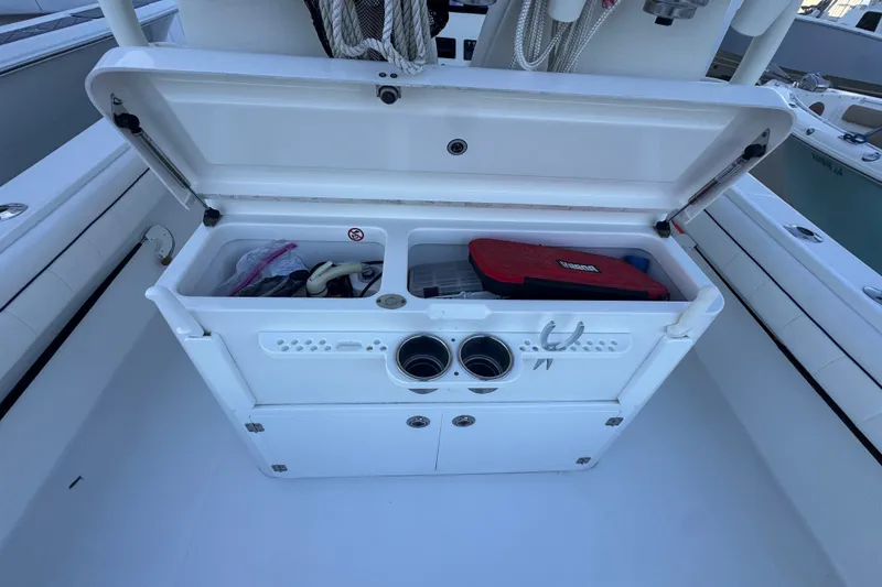 Slide: The Image of Open storage compartment on a 2016 Regulator 34 boat, containing various boating accessories. - 15