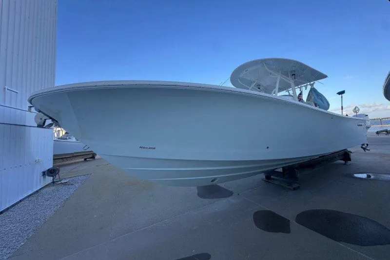 The Image of A 2016 Regulator 34 boat is on land. It features a sleek, white design. - 0