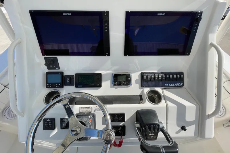 Slide: The Image of Control panel of a 2016 Regulator 34 boat with dual Simrad displays. - 7