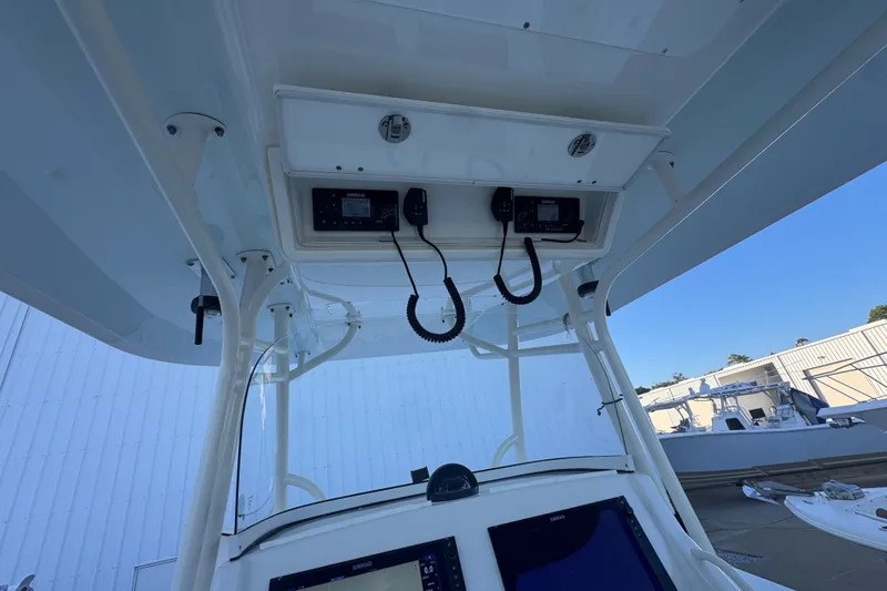 Slide: The Image of 2016 Regulator 34 boat console with electronic controls and overhead storage. - 8