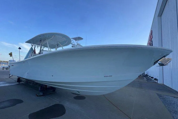 Slide: The Image of A 2016 Regulator 34 boat is on a trailer next to a building. - 3
