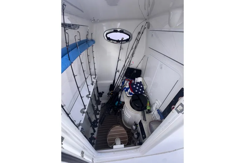 Slide: The Image of Interior of 2016 Regulator 34 boat with fishing rods and gear storage. - 29
