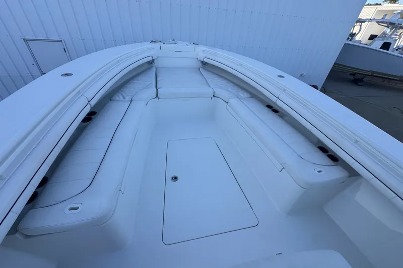 Slide: The Image of 2016 Regulator 34 boat interior with white cushioned seating and spacious deck. - 23