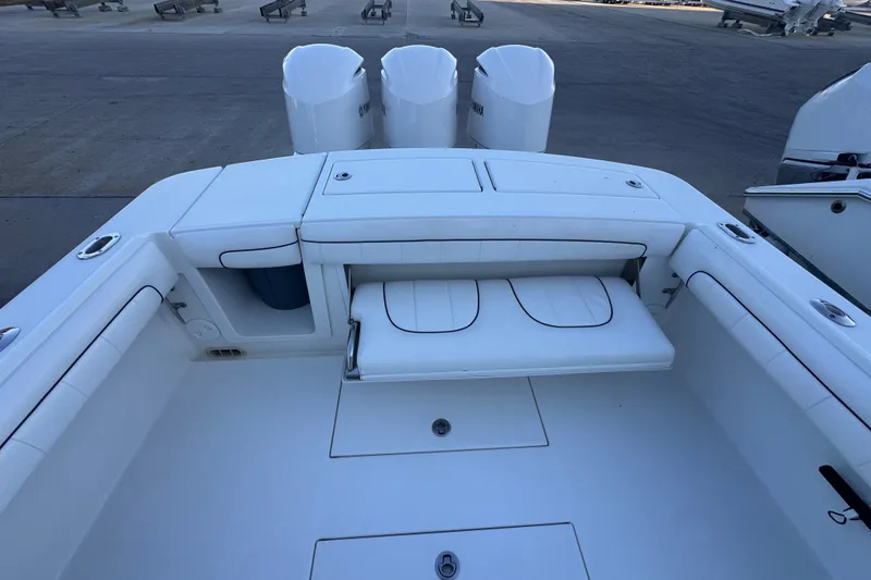 Slide: The Image of 2016 Regulator 34 boat interior with seating and triple outboard engines. - 9