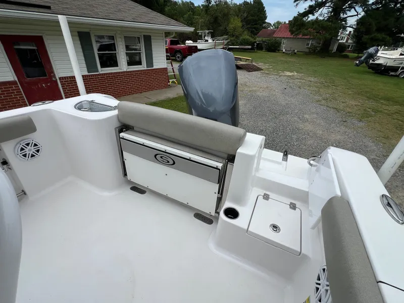 Slide: The Image of The image shows the stern of a 2021 Sportsman Open 232 Center Console boat with gray upholstery. - 25