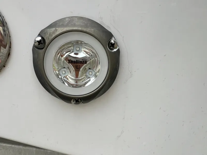 Slide: The Image of A SeaBlaze LED light is mounted on the white exterior of a Sportsman Open 232 Center Console boat. - 13