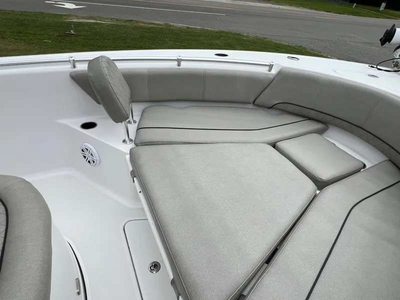 Slide: The Image of The image shows the bow area of a 2021 Sportsman Open 232 Center Console boat with gray upholstery. - 44