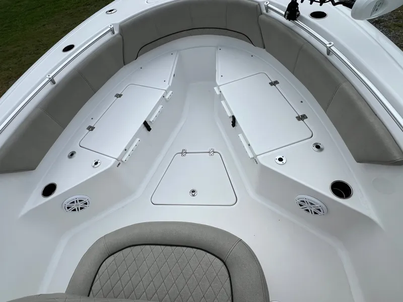 Slide: The Image of The image shows the bow area of a 2021 Sportsman Open 232 Center Console boat with cushioned seating. - 35