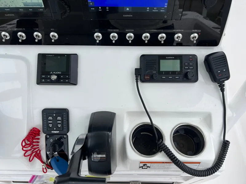 Slide: The Image of The image shows the dashboard of a 2021 Sportsman Open 232 Center Console boat with various controls and instruments. - 17