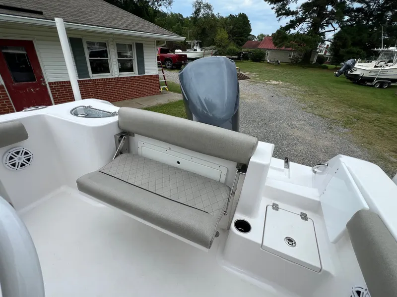 Slide: The Image of The image shows the stern of a 2021 Sportsman Open 232 Center Console boat with gray upholstery. - 26