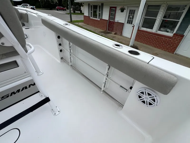 Slide: The Image of The image shows the deck of a 2021 Sportsman Open 232 Center Console boat with seating and speakers. - 28