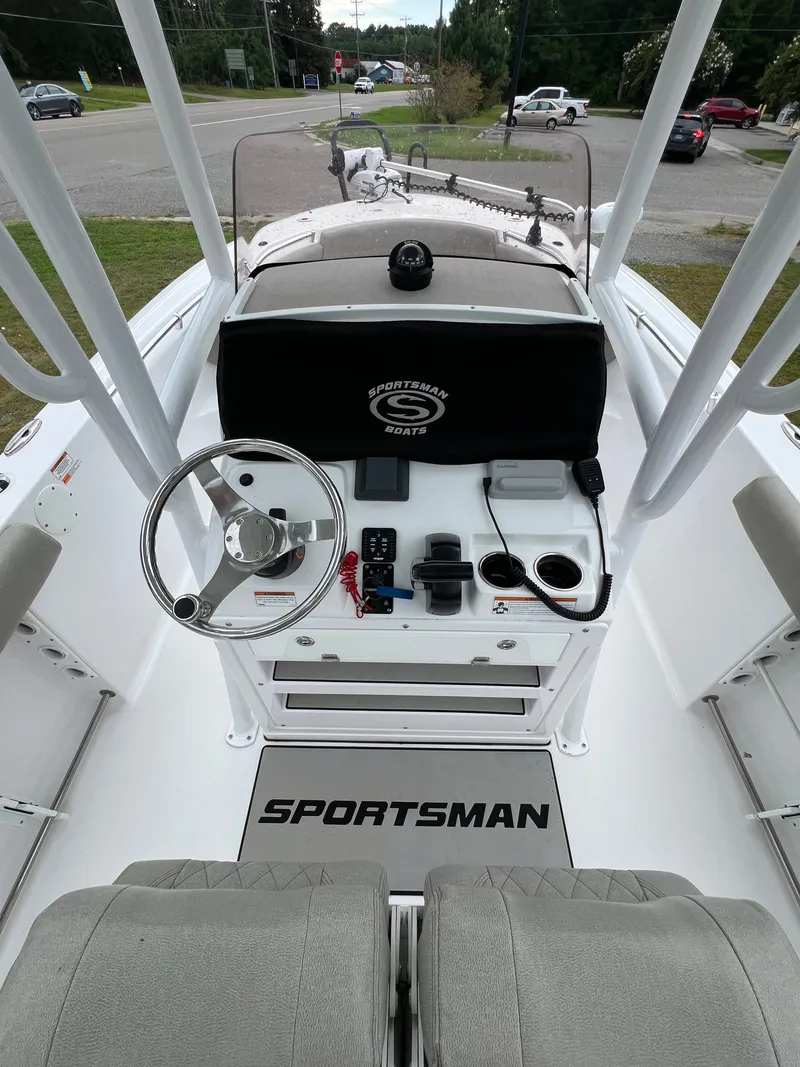 Slide: The Image of The image shows the cockpit of a 2021 Sportsman Open 232 Center Console boat. - 14