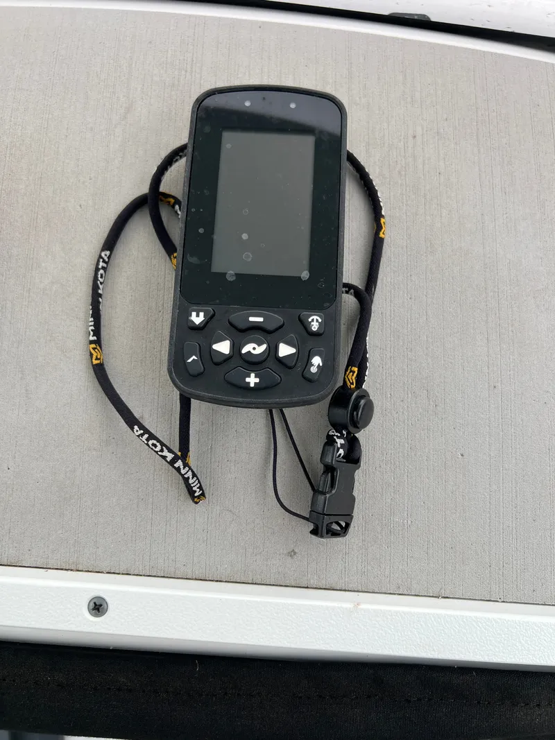 Slide: The Image of A portable electronic device with a screen and buttons rests on a boat console. - 32