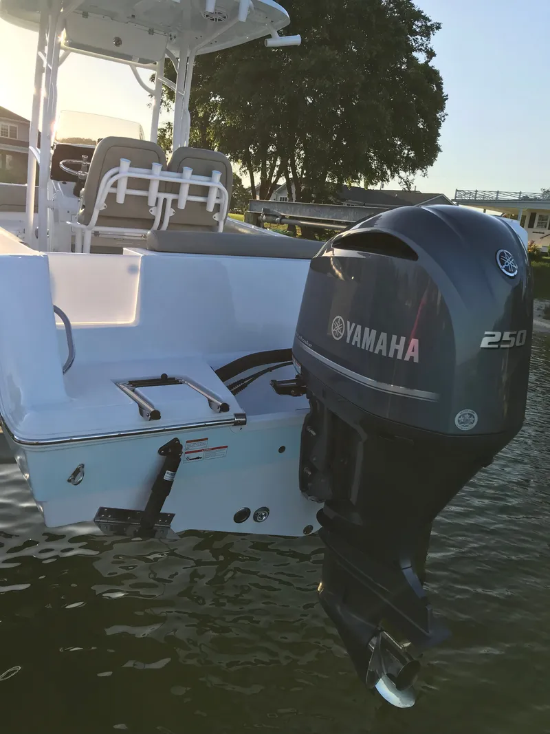 Slide: The Image of A 2021 Sportsman Open 232 Center Console boat with a Yamaha 250 outboard motor. - 2