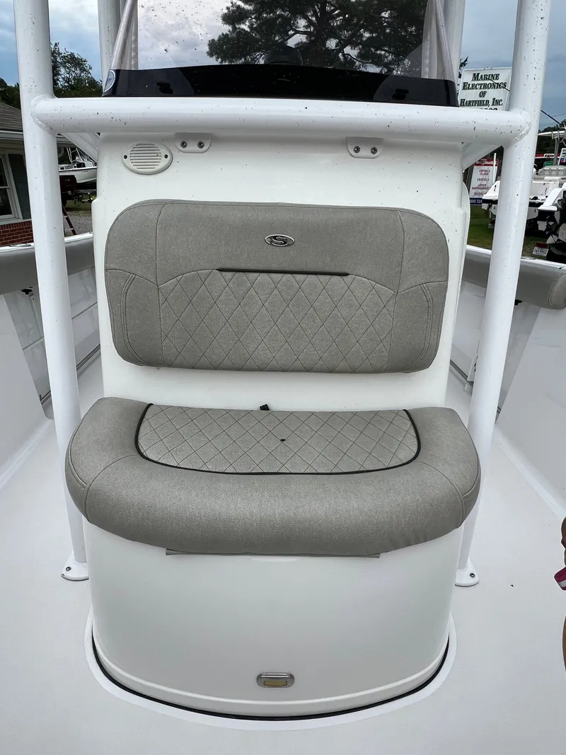 Slide: The Image of The image shows a cushioned seat on a 2021 Sportsman Open 232 Center Console boat. - 34
