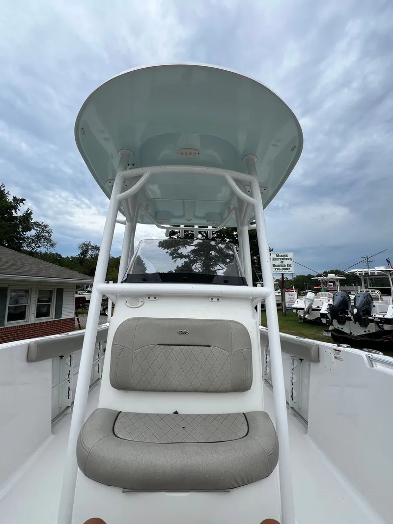 Slide: The Image of A 2021 Sportsman Open 232 Center Console boat with gray upholstery and a T-top. - 33