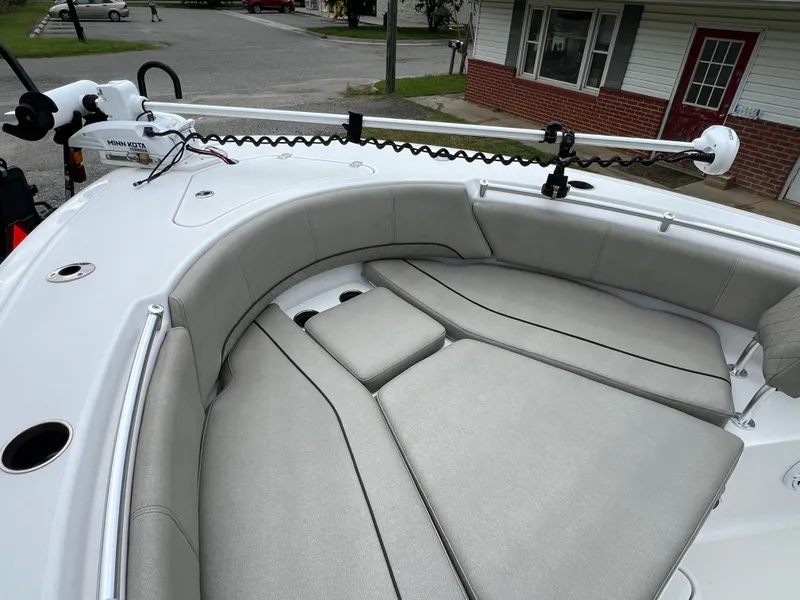 Slide: The Image of The image shows the bow of a 2021 Sportsman Open 232 Center Console boat with gray cushions. - 46
