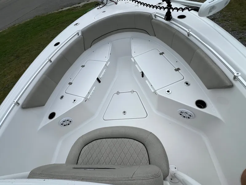 Slide: The Image of The image shows the bow of a Sportsman Open 232 Center Console boat with seating and storage. - 36