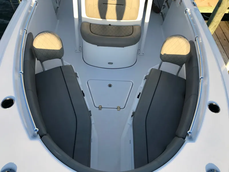 Slide: The Image of The image shows the bow area of a 2021 Sportsman Open 232 Center Console boat with cushioned seating. - 4