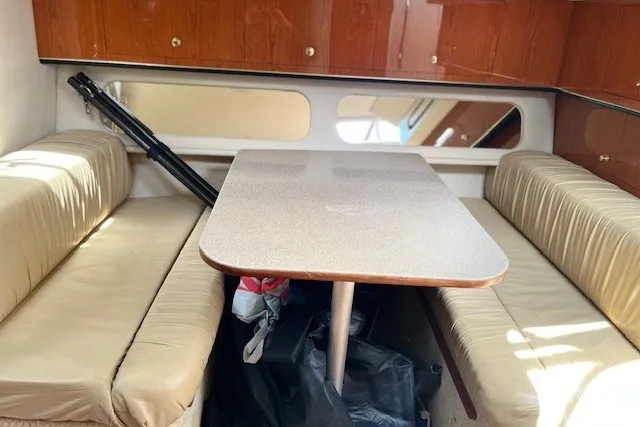 Slide: The Image of Interior of 2001 Sea Ray 340 Amberjack with dining area and beige seating. - 10