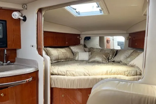 Slide: The Image of Interior of 2001 Sea Ray 340 Amberjack, featuring a cozy cabin with a plush bed. - 7