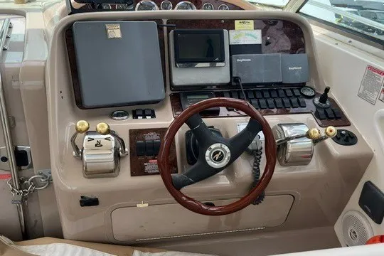 Slide: The Image of Cockpit of 2001 Sea Ray 340 Amberjack with steering wheel and navigation controls. - 4