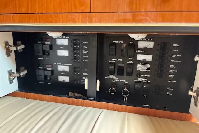 Slide: The Image of Electrical control panel inside a 2001 Sea Ray 340 Amberjack boat, featuring various switches and indicators. - 5