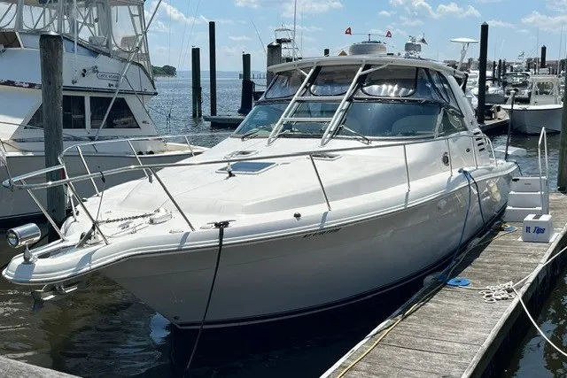 The Image of 2001 Sea Ray 340 Amberjack docked at a marina under a clear sky. - 0