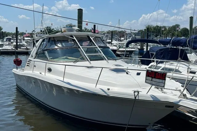Slide: The Image of 2001 Sea Ray 340 Amberjack boat docked, for sale sign visible, sunny marina setting. - 1