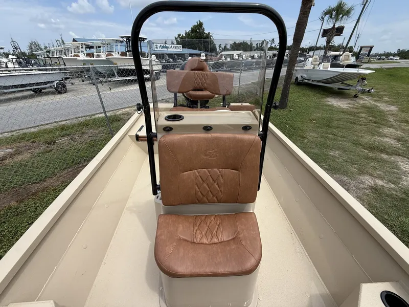 Slide: The Image of The image shows the cockpit of a G3 Bay GX21 boat with brown leather seats and a helm. - 7
