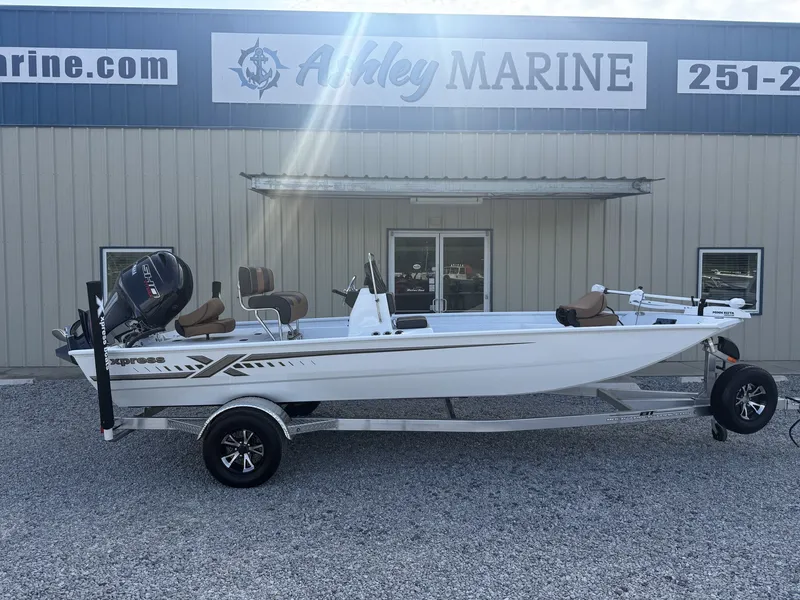 The Image of A white Xpress Xplorer CC Bay Series XP20CC boat on a trailer in front of a building. - 1