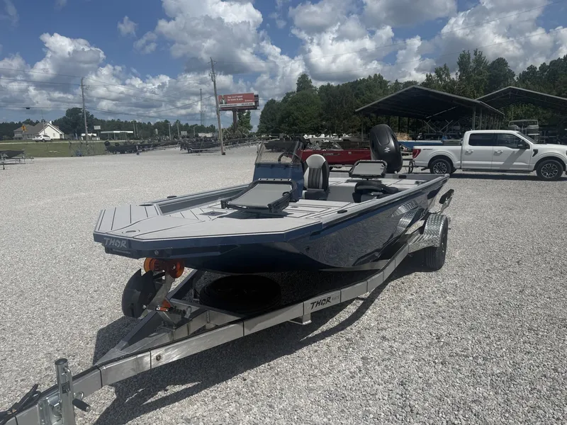 Slide: The Image of A 2027 Thor Lake Hammer 1900 SC boat on a trailer in a gravel lot. - 4