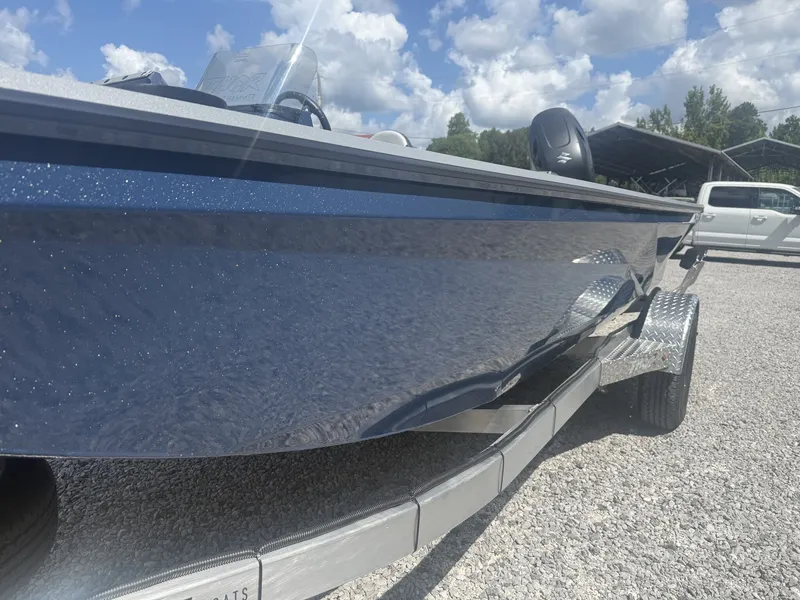 Slide: The Image of A shiny blue boat on a trailer, with a cloudy sky in the background. - 5