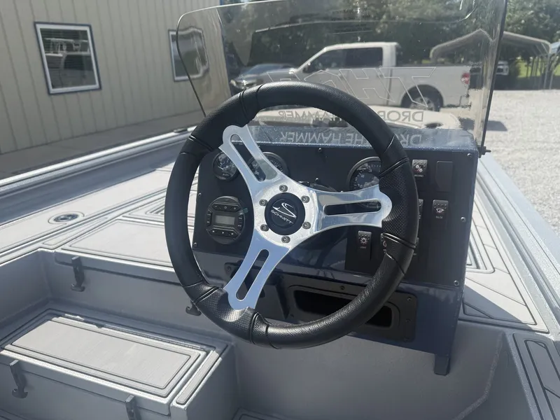 Slide: The Image of The image shows the cockpit of a Thor Lake Hammer 1900 SC boat with a modern steering wheel and instruments. - 7