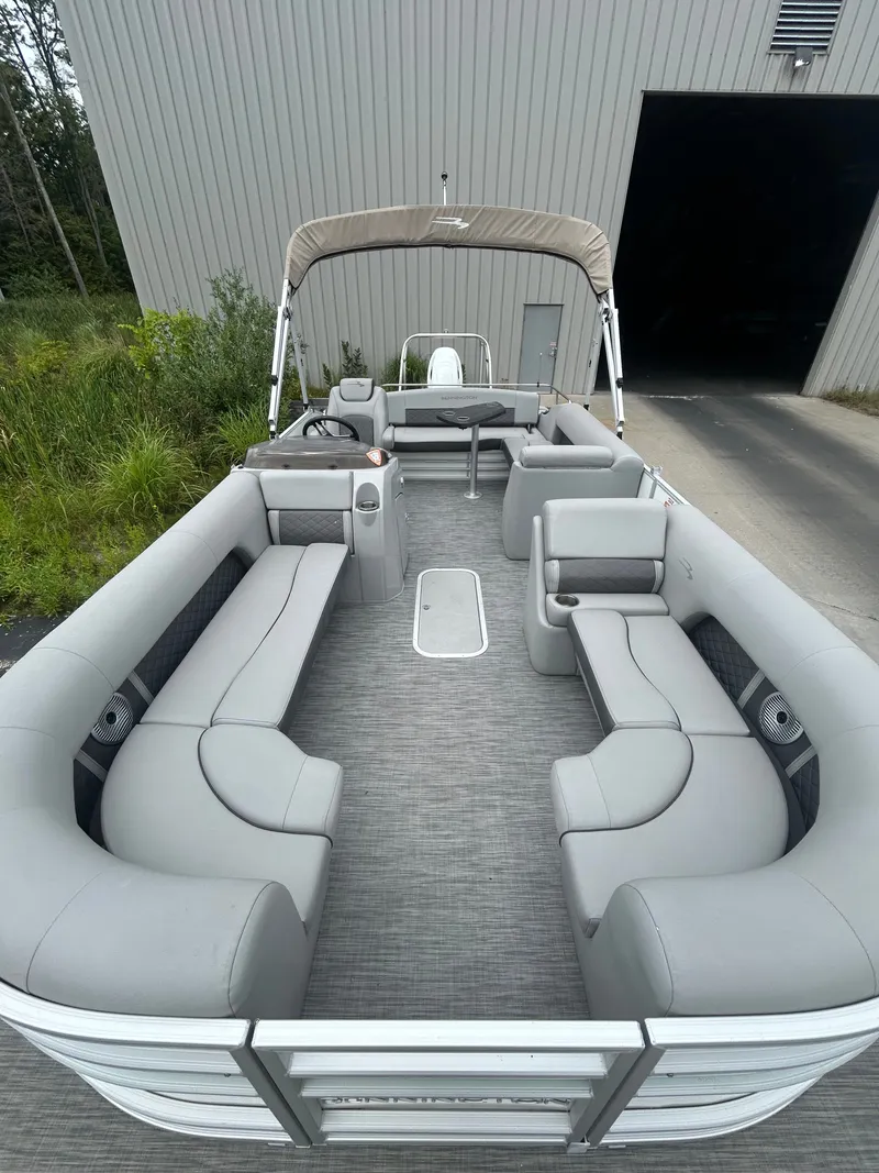 Slide: The Image of The image shows the interior of a 2021 Bennington 23LSBSD pontoon boat with gray upholstery. - 6