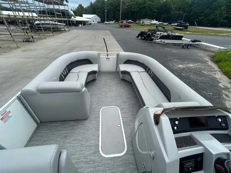 Slide: The Image of The image shows the spacious deck of a 2021 Bennington 23LSBSD pontoon boat with gray seating. - 7