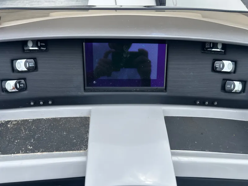 Slide: The Image of The image shows the dashboard of a 2021 Bennington 23LSBSD with a central screen. - 11