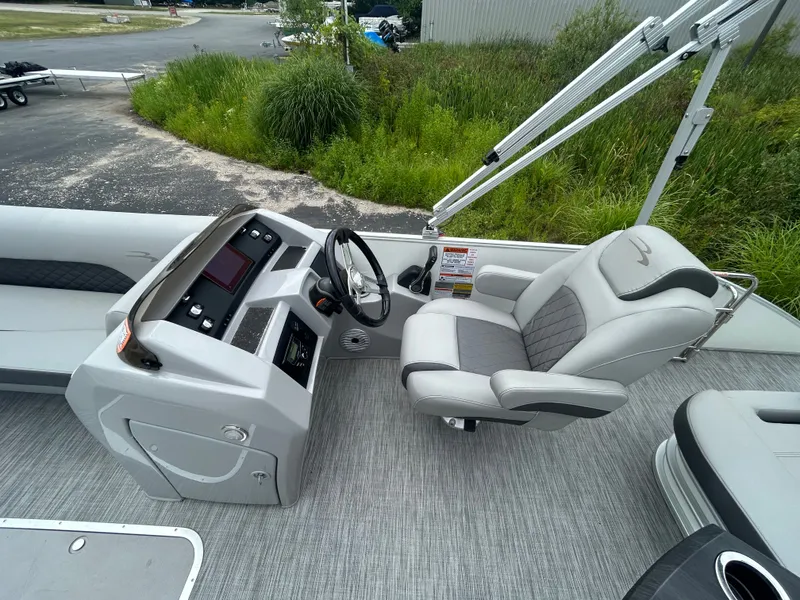 Slide: The Image of The image shows the cockpit of a 2021 Bennington 23LSBSD with a sleek steering wheel and gray upholstery. - 8
