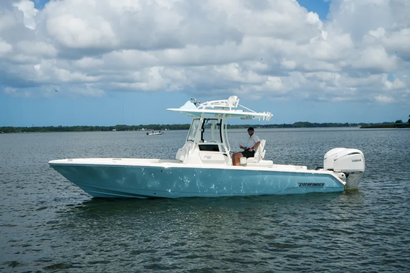 Slide: The Image of 2027 Pathfinder 2800 Hybrid boat on calm water under a cloudy sky. - 17