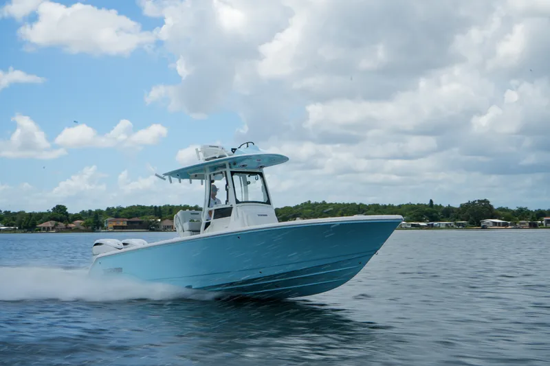 Slide: The Image of 2027 Pathfinder 2800 Hybrid boat cruising on a lake under a cloudy sky. - 20